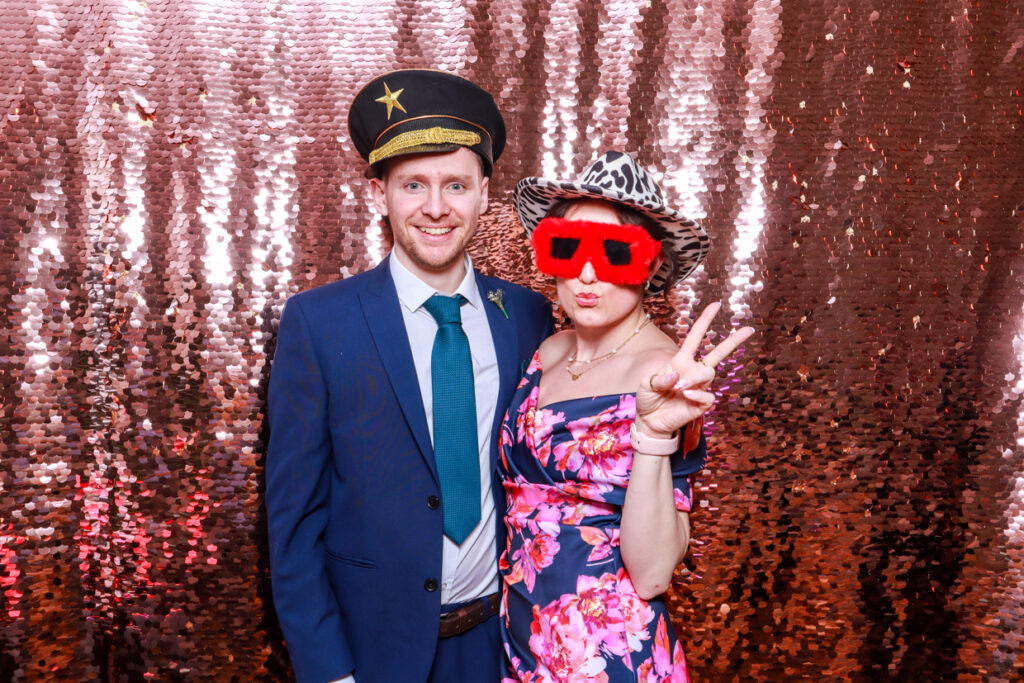 couple posing for a birthday party photo booth hire in the cotswolds