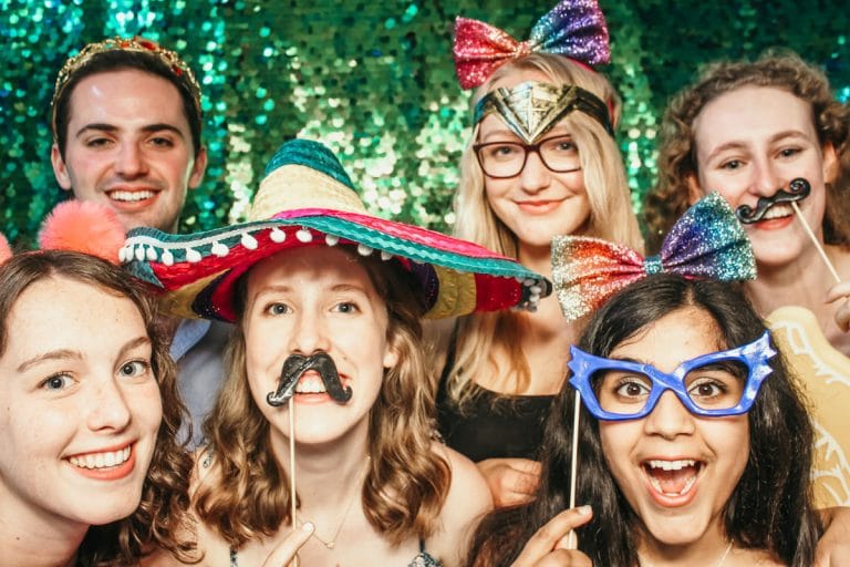 birthday party entertainment with green sequins back drop for a crazy fun photo booth