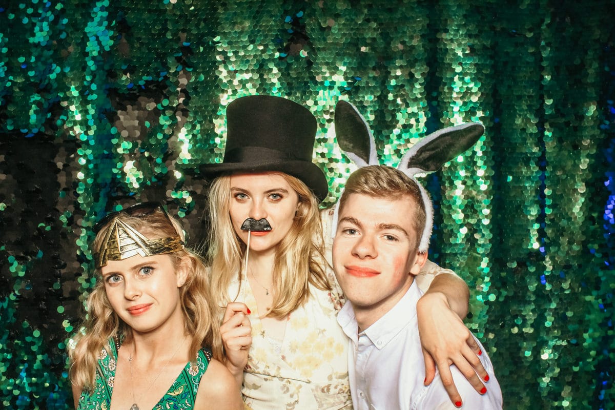 friends having fun with a photo booth in the cotswolds for a birthday party