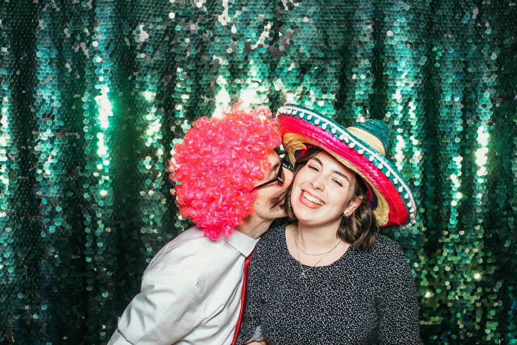 kiss in photo booth at elmore court weedding venue