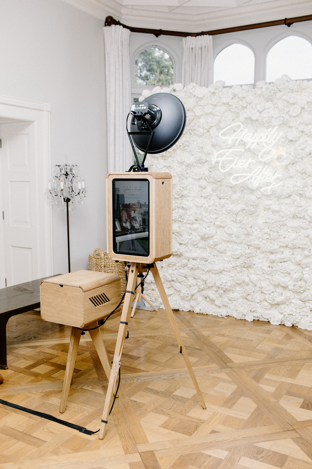 mad hat photo booth rental with white floral backdrop