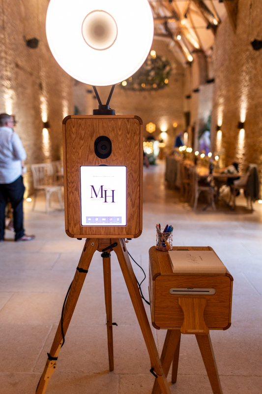 mad hat photo booth setup near the bar area at ivy lodge wedding venue in cirencester with the icon luxury photo booth hire
