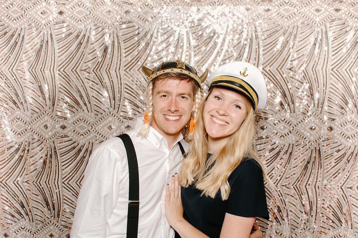 couple posing in front of boho sequins backdrop at coombe lodge blagdon