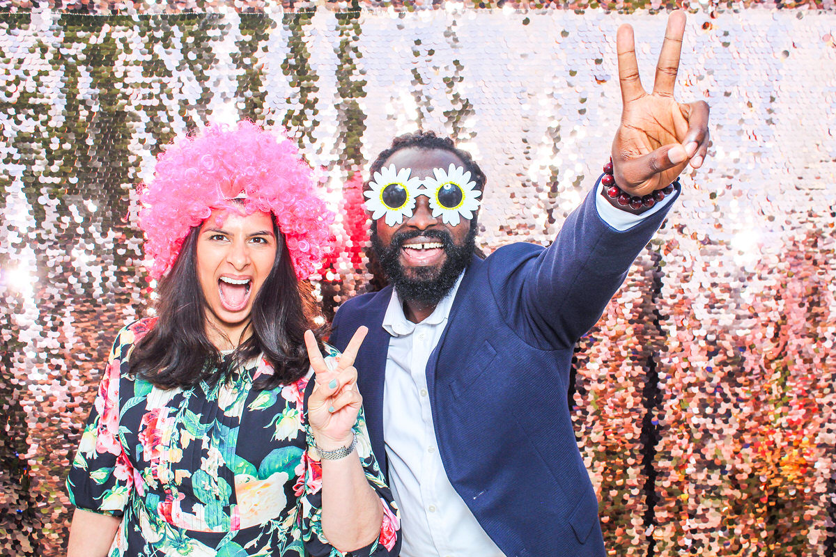 Really fun couple posing for mad hat photo booth