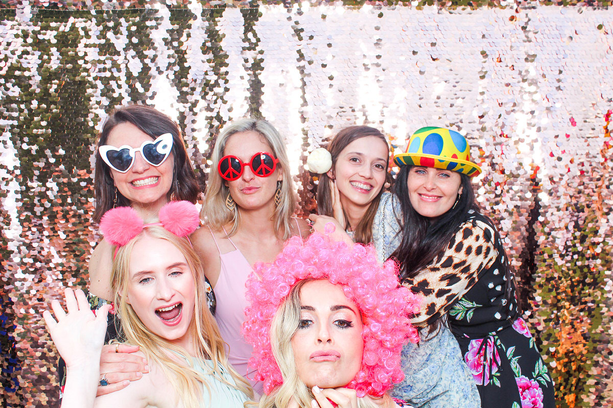 wedding guests posing for mad hat photobooth during a Lapstone Barn Wedding