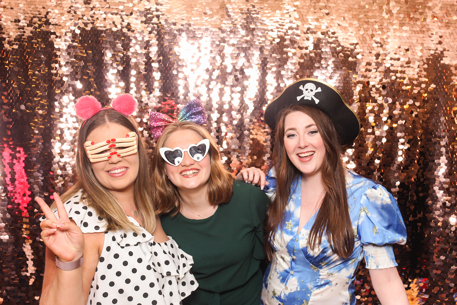 wedding guests posing with props for a vintage booth in cotswolds