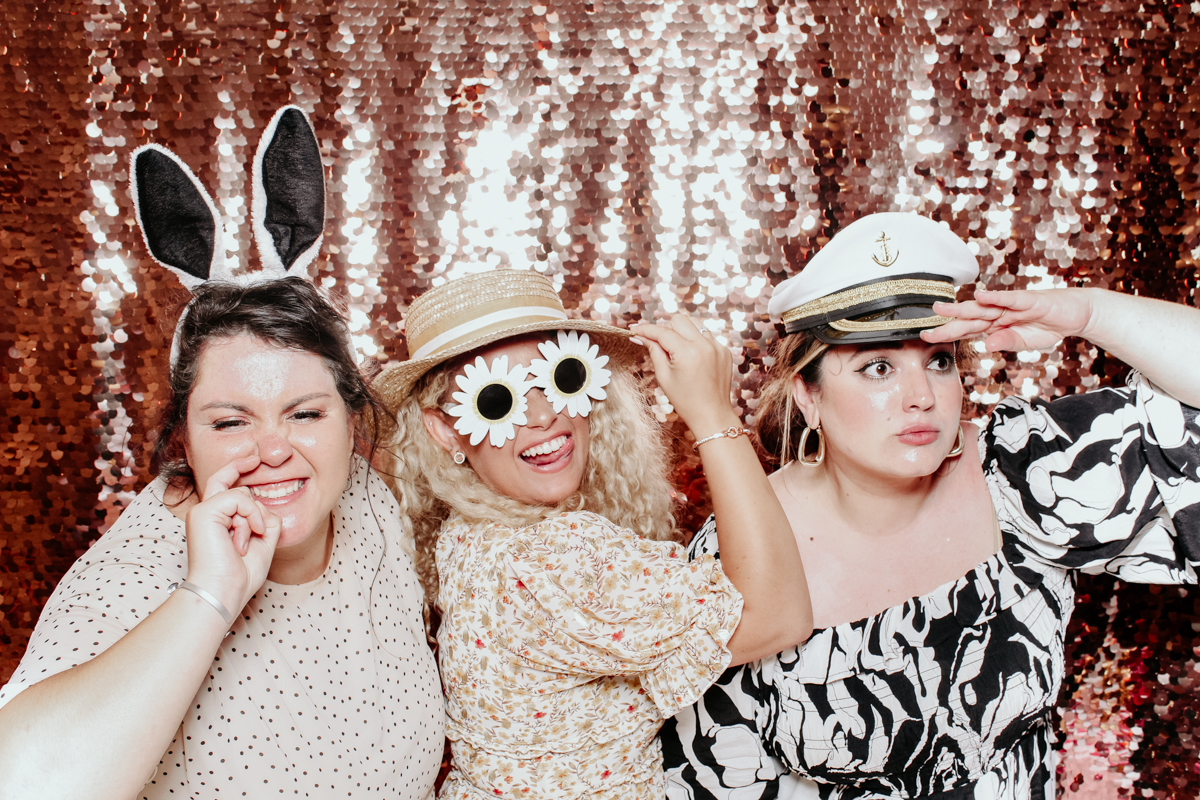 guests having fun during a wedding in tetbury, with mad hat photo booth