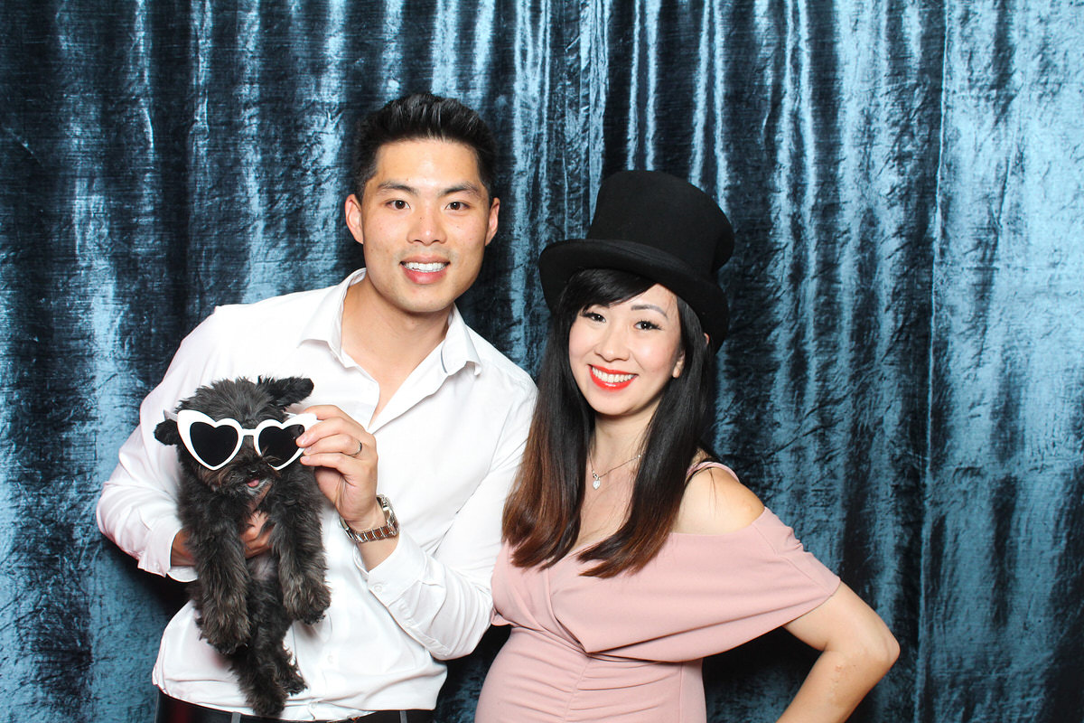 couple posing with a dog during a wedding reception photo booth at whatley manor 