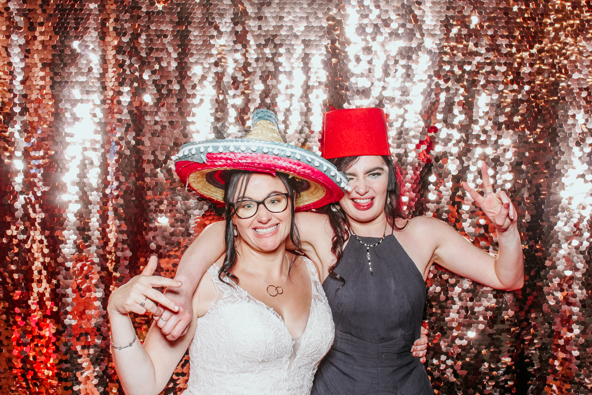 bride and friend posing for a fun photo booth wedding