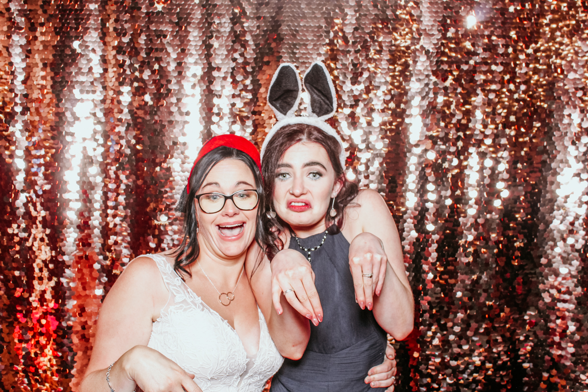 bride and friend doing fun poses for a photo booth event at Clearwell Castle 