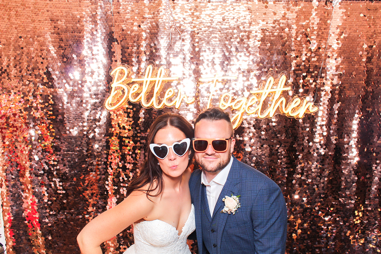 couple with wedding neon sign for a photo booth at Hyde House wedding venue