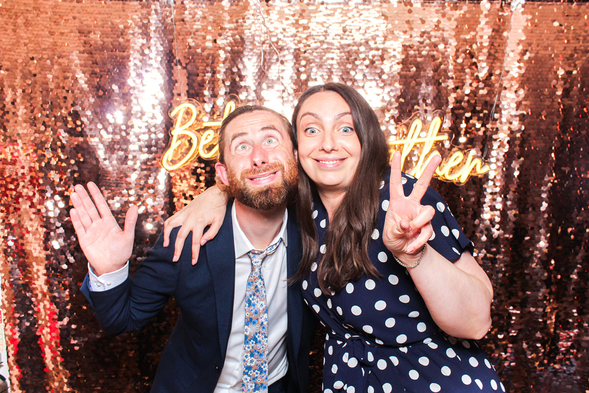 funny couple with the better together neon sign at a hyde house wedding