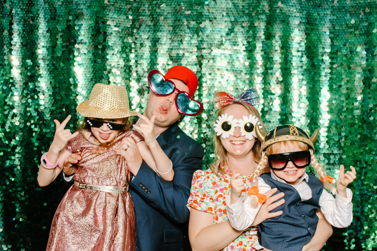 fun photo booth with green sequins backdrop in the cotswolds