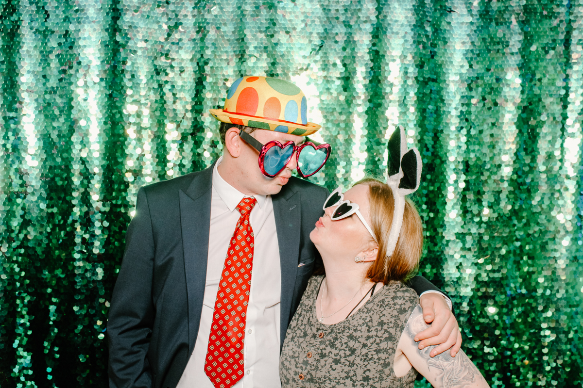 couple with hats and glasses during a photo booth event near Cotswolds 