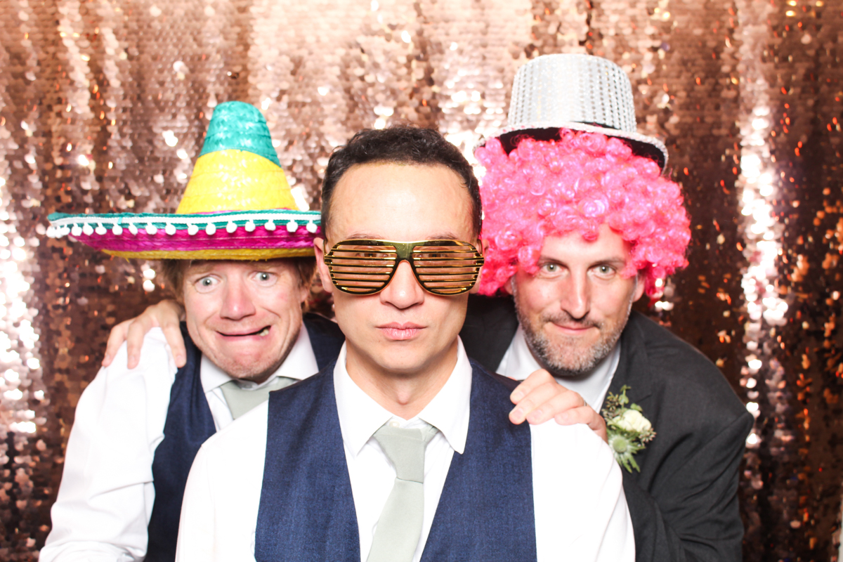 guys posing for a photo booth during a wedding at lapstone barn