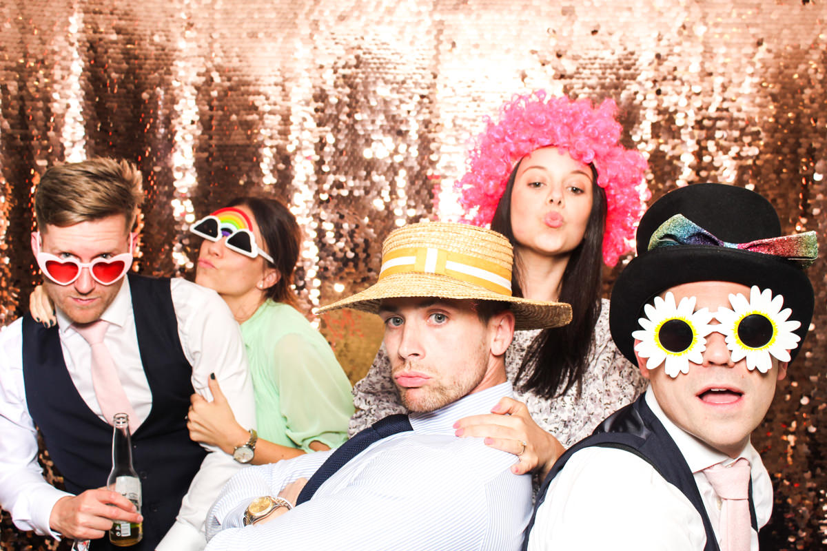 fun guests using mad hat photo booth for a lapstone barn wedding cotswolds