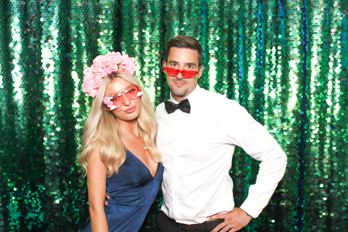 couple posing for a cotswolds photo booth during a wedding party entertainment