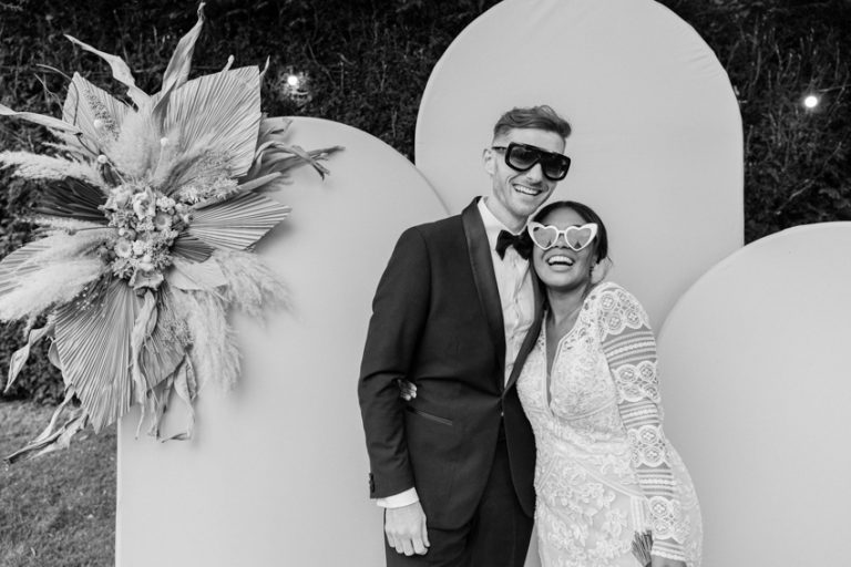 black and white image from a wedding with a photo booth