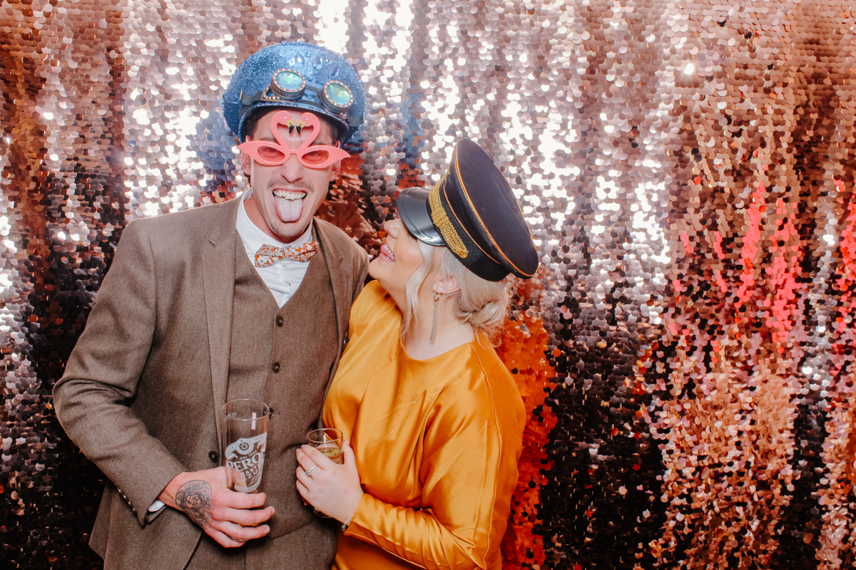 couple posing with champagne sequins during a wedding reception near cirencester