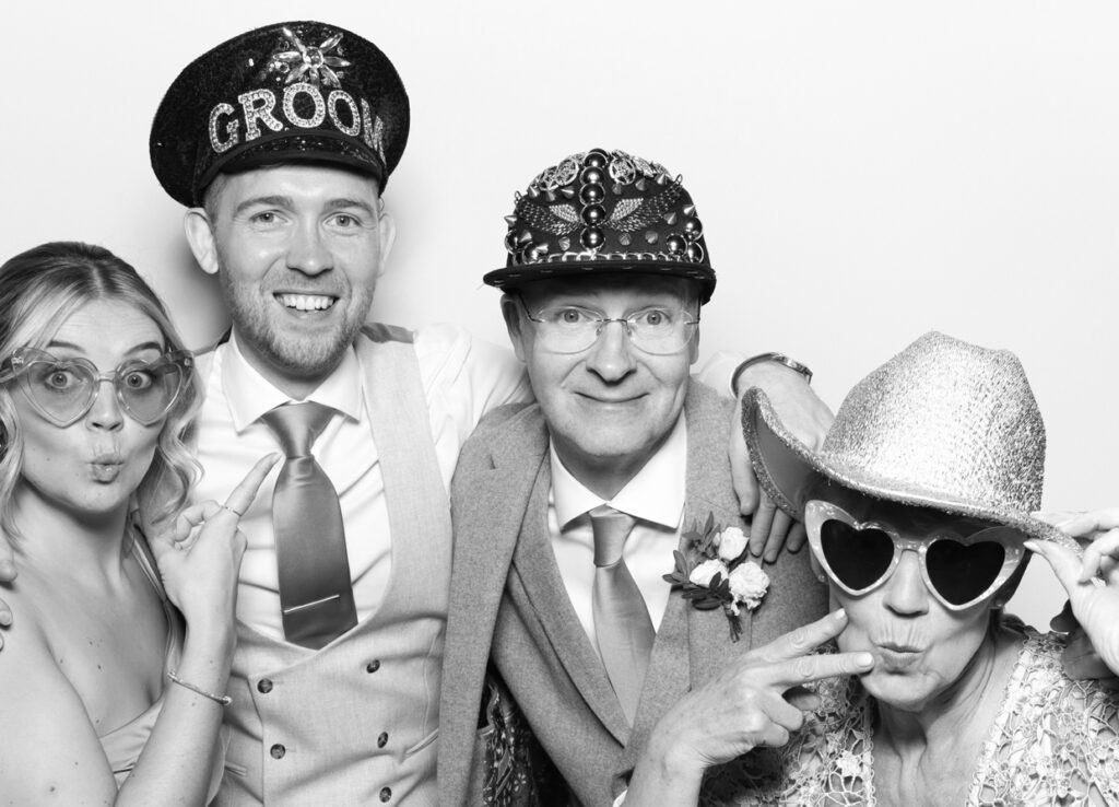 black and white photo of guests posing against a white backdrop for a kardashian style photography rental