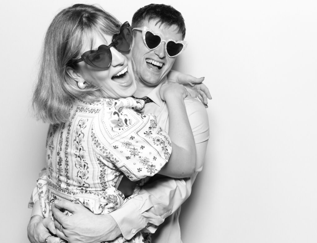 best Gloucestershire photo booth hire for a corporate party entertainment with guests wearing sunglasses and posing against a white backdrop