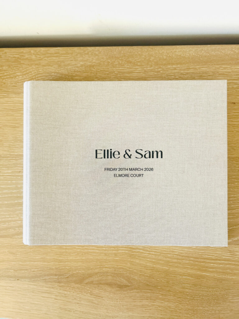 photo booth guest book for weddings with a custom linen cover with couples name, date and venue engraved on the natural cover