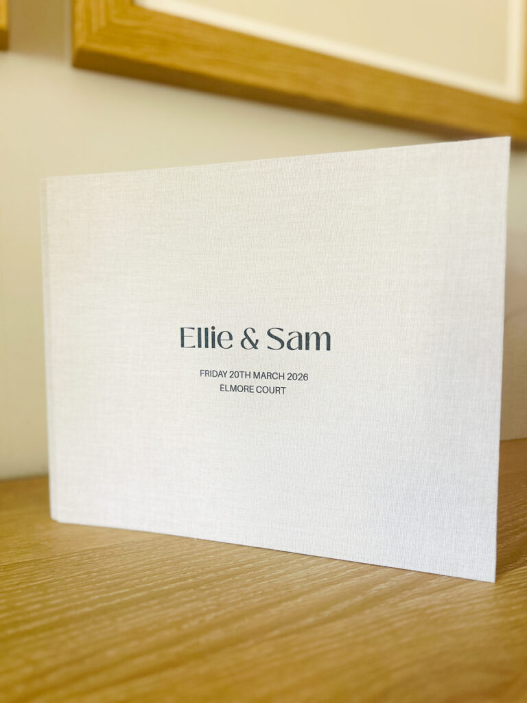 photo booth guest book for weddings with a custom linen cover with couples name, date and venue engraved on the cover
