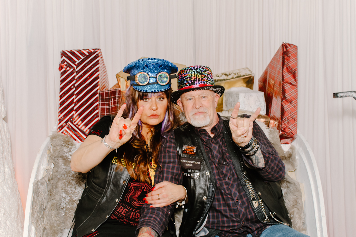 biker couple on a sledge during a christmas themed wedding photo booth hire