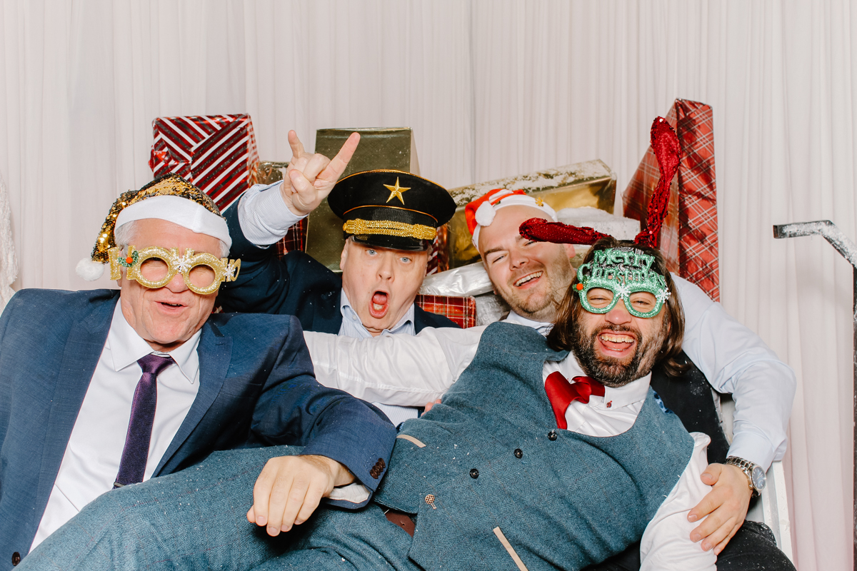 guests during a wedding having fun on the sledge posing for the photo booth