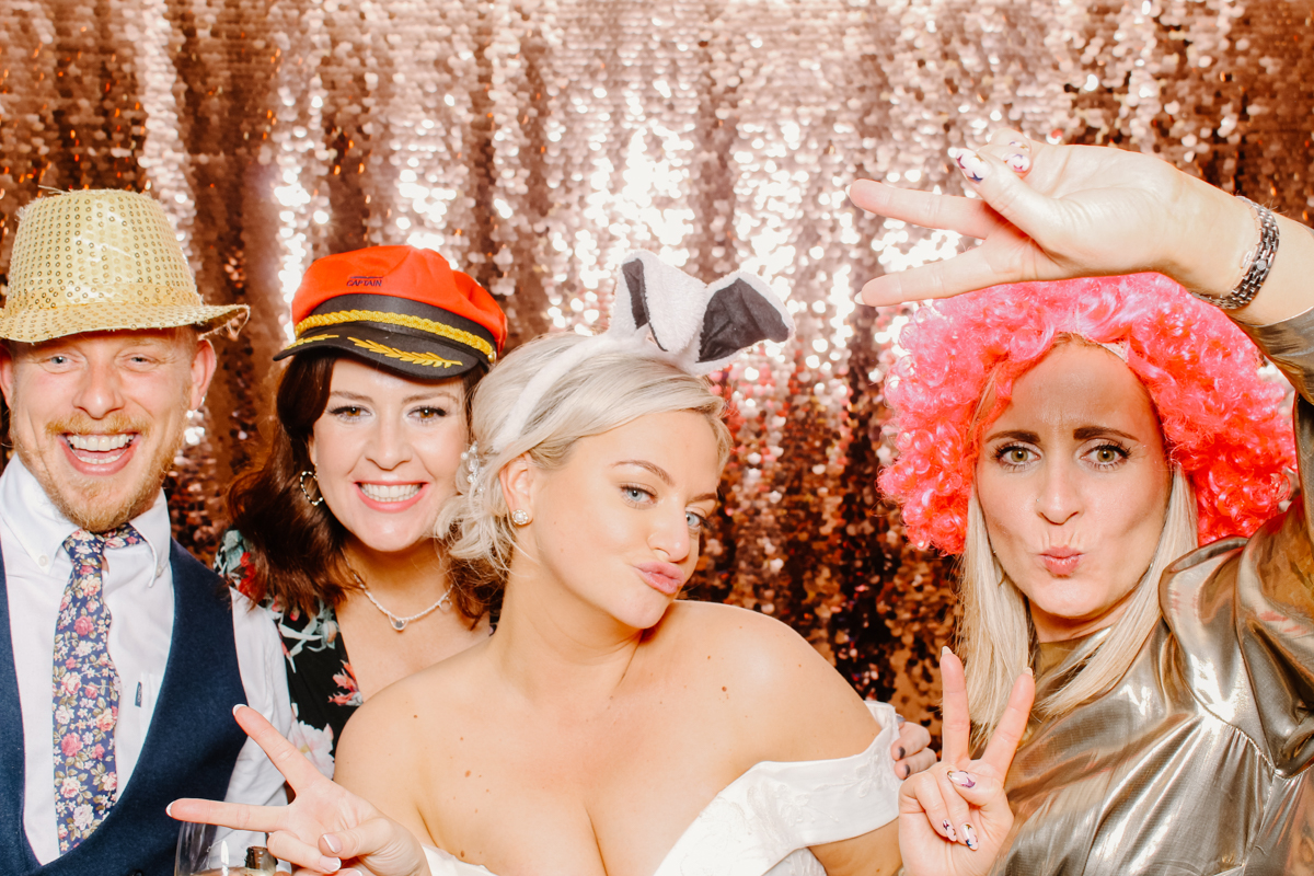 guests posing during a wedding party entertainment against a sequins backdrop