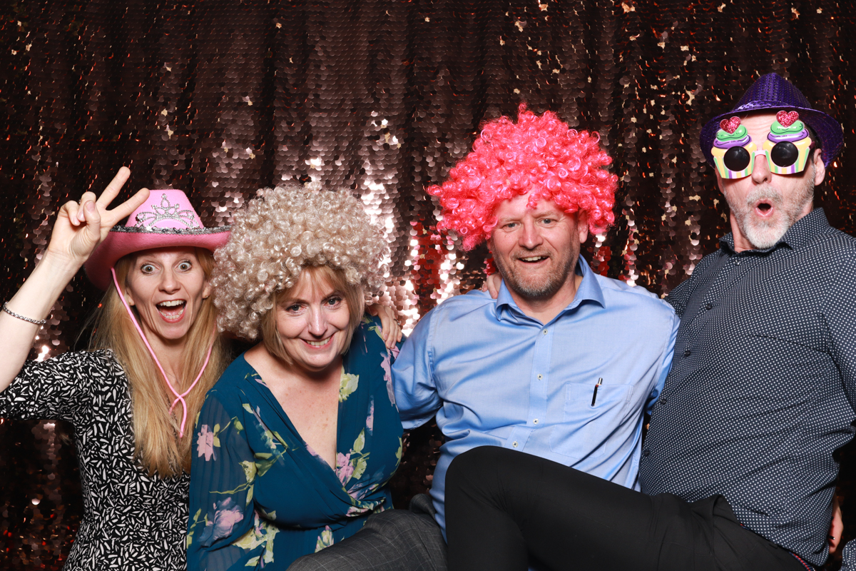 group of people posing for a photo booth party at cripps barn wedding reception