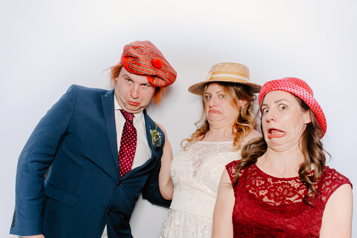 guests making silly poses for the photo booth during a wedding party at the swan hotel