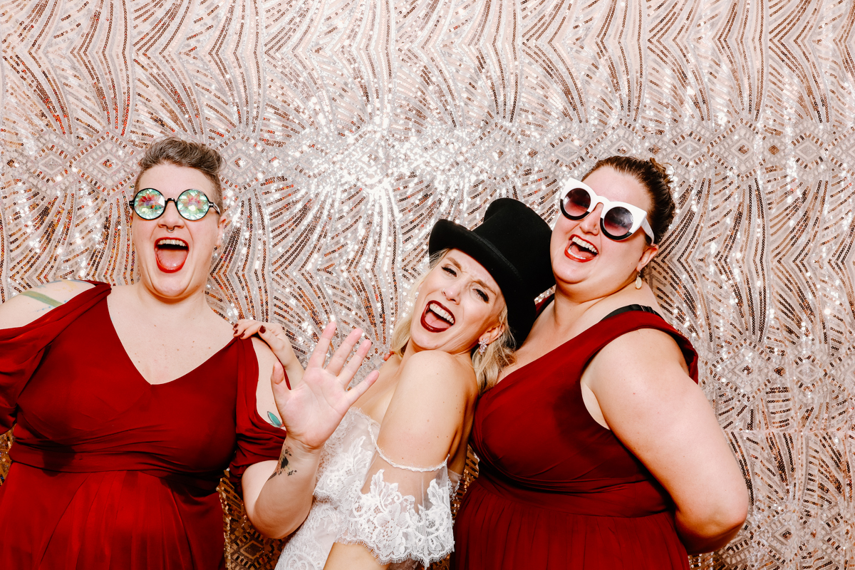 ladies and bride posing for a photo booth hire during the wedding reception