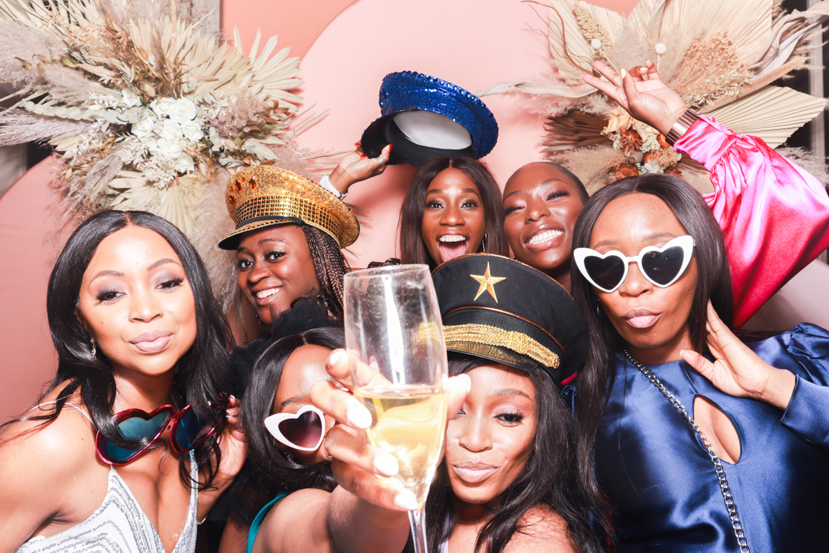 large group of wedding guests posing for a luxury photo booth in cotswolds