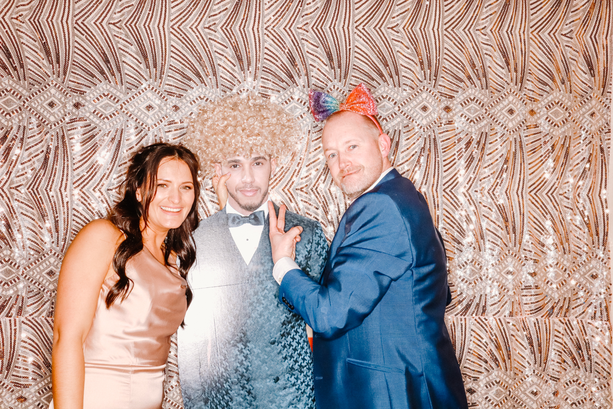 guests posing with a cardboard male image, during a photo booth event at old gore in cotswolds