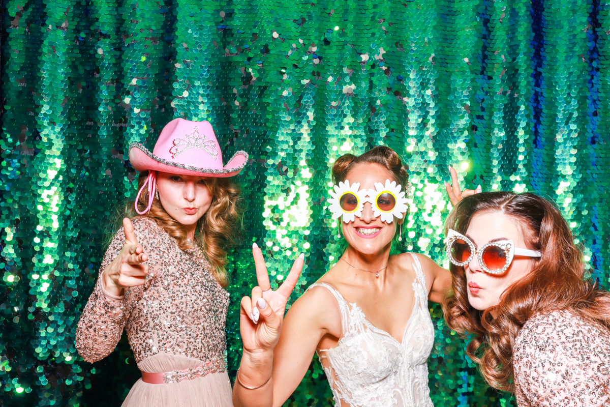 bride and bridesmaids during the wedding party posing for a photo booth