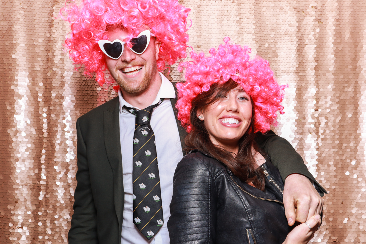 guests wearing pink wigs for a wedding party during a photo booth hire