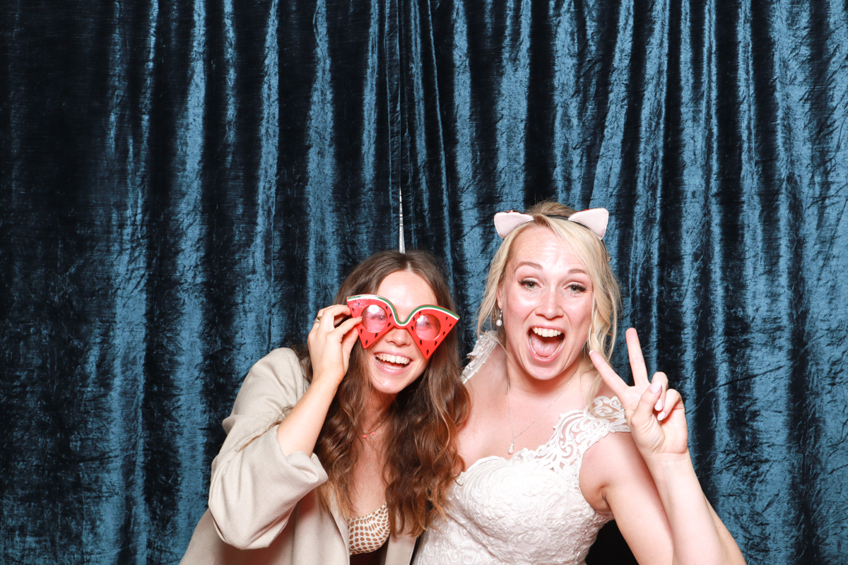 bride posing with friend for a cotswolds photo booth hire