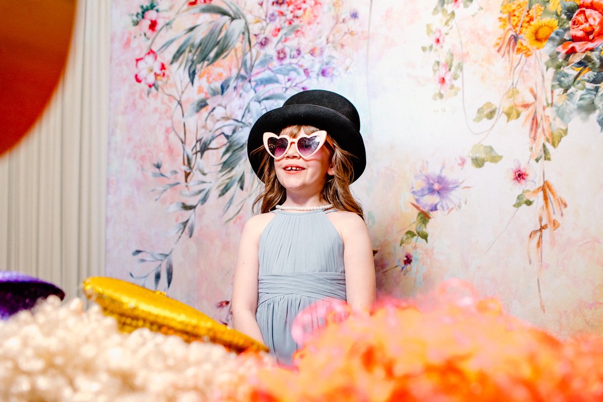 little girl with props during a wedding photo booth party in Chipping Norton