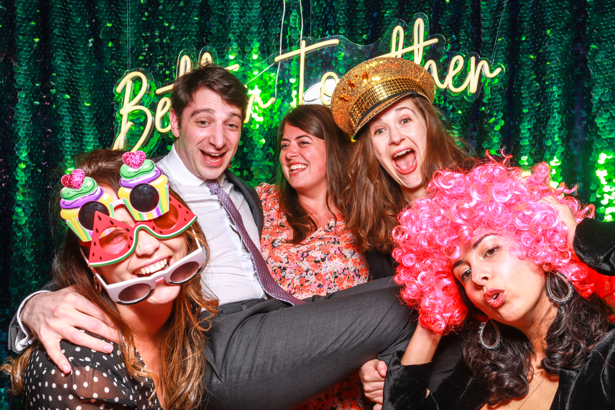 fun wedding guests posing during a photo booth party entertainment