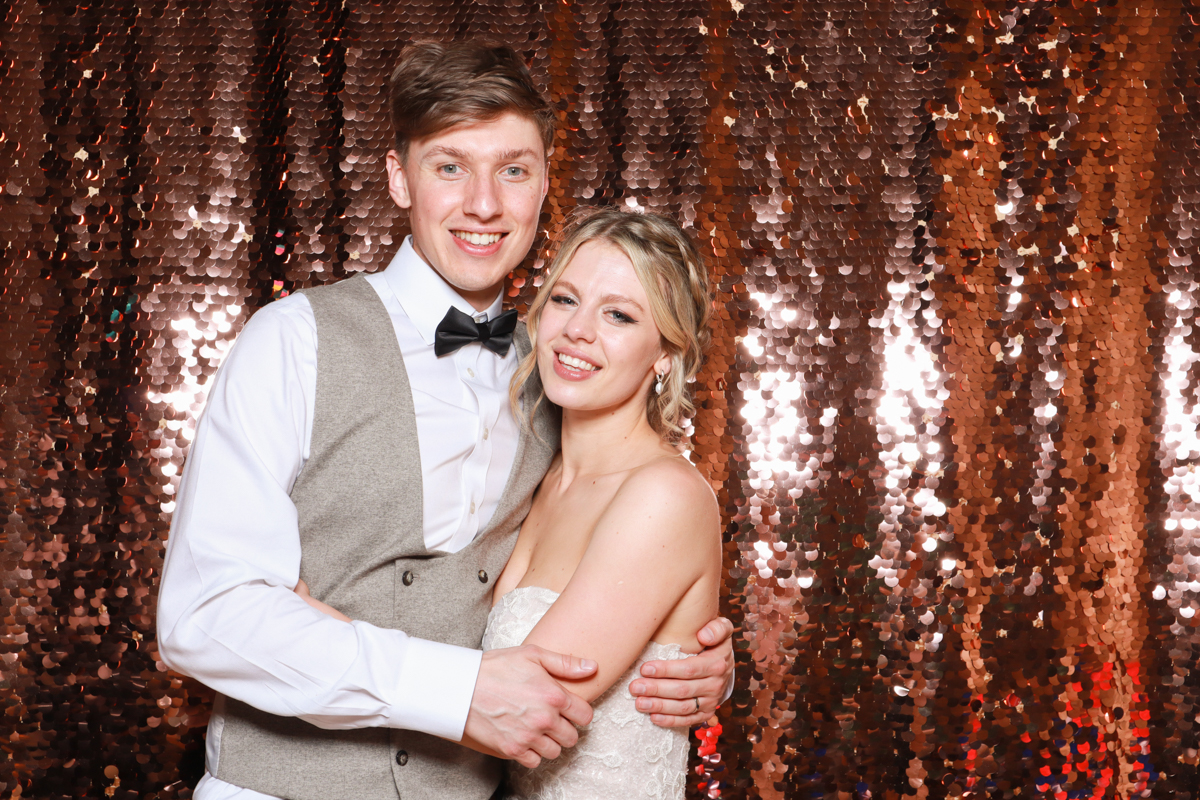 bride and groom posing for a photo booth during their wedding at old gore