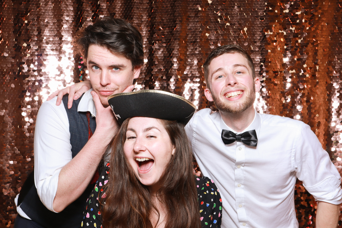 guests during a photo booth party posing with sequins