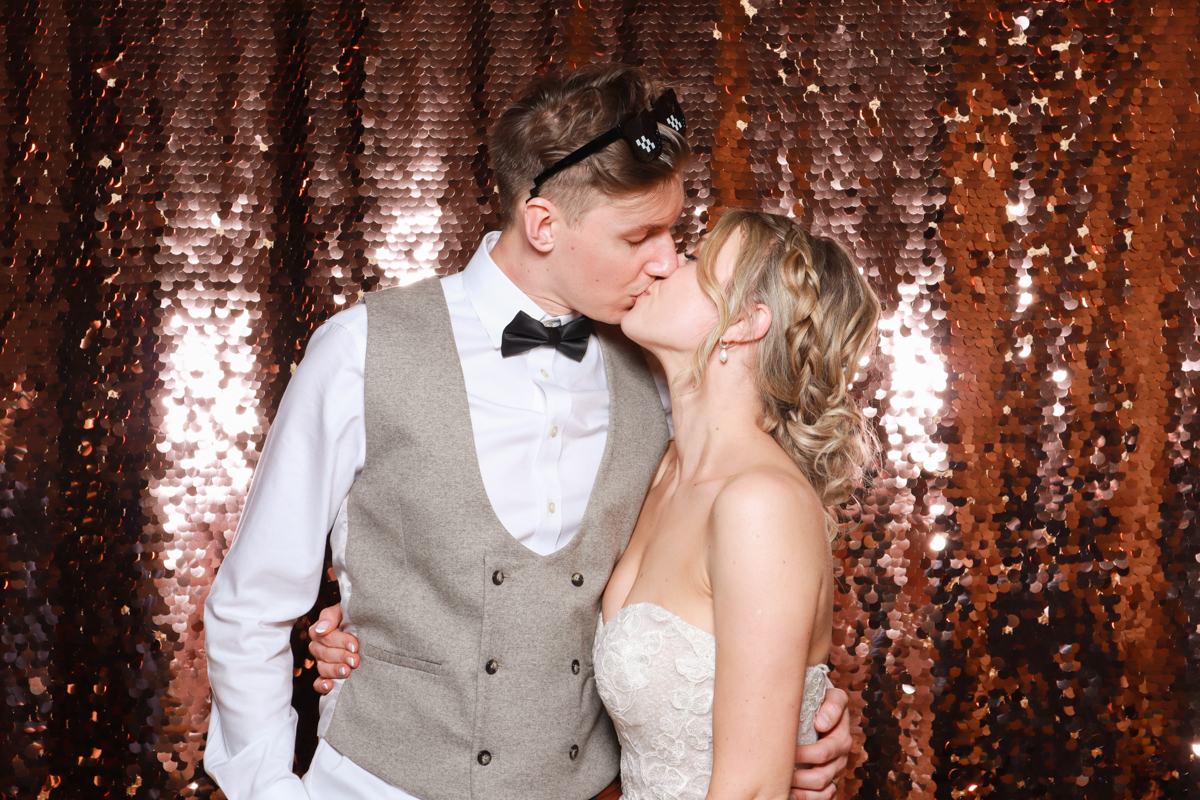 bride and groom kissing during the photo booth 