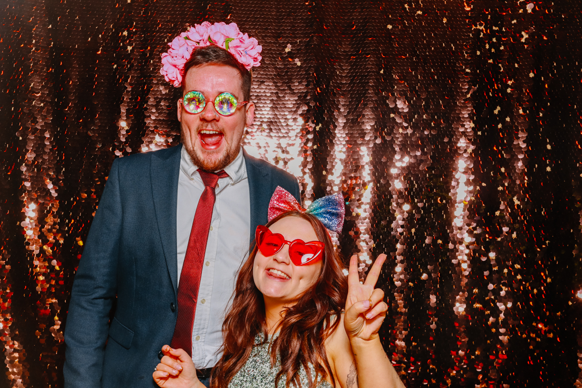 wedding guests for a stone barn wedding posing for the photo booth 