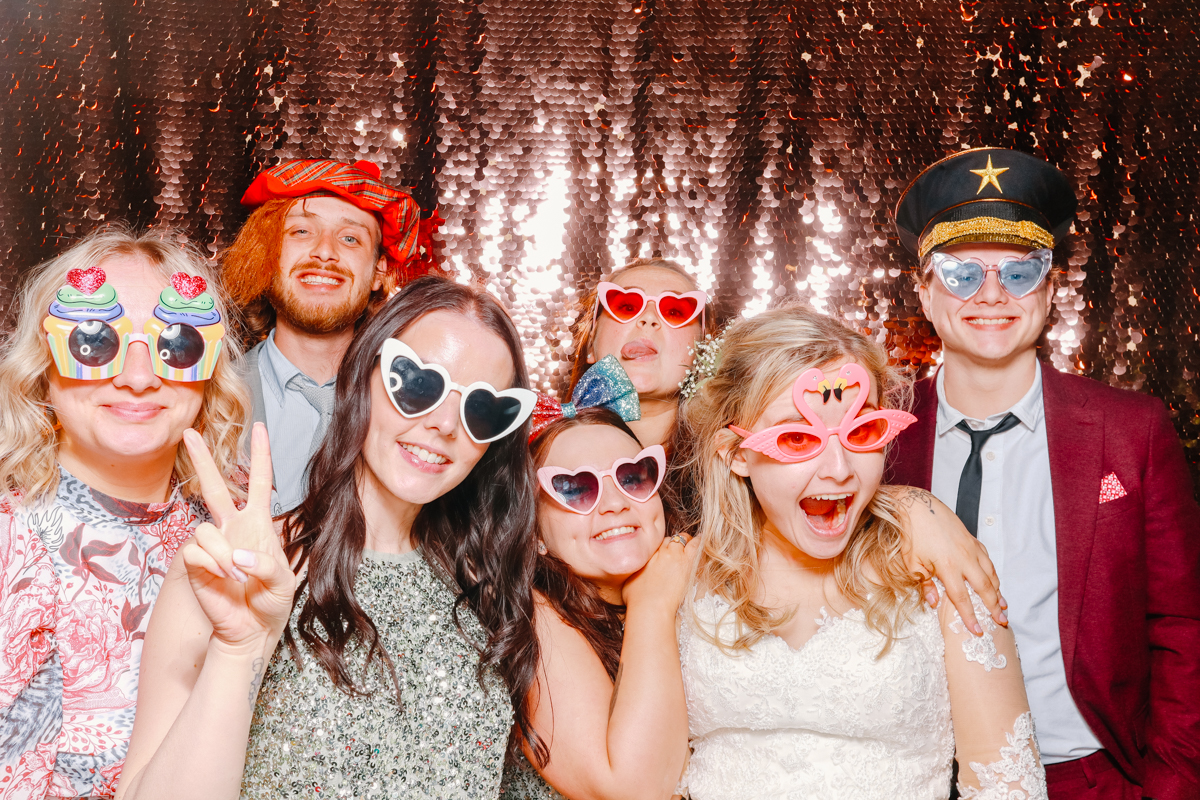 group of wedding guests posing with their party entertainment at stone barn 