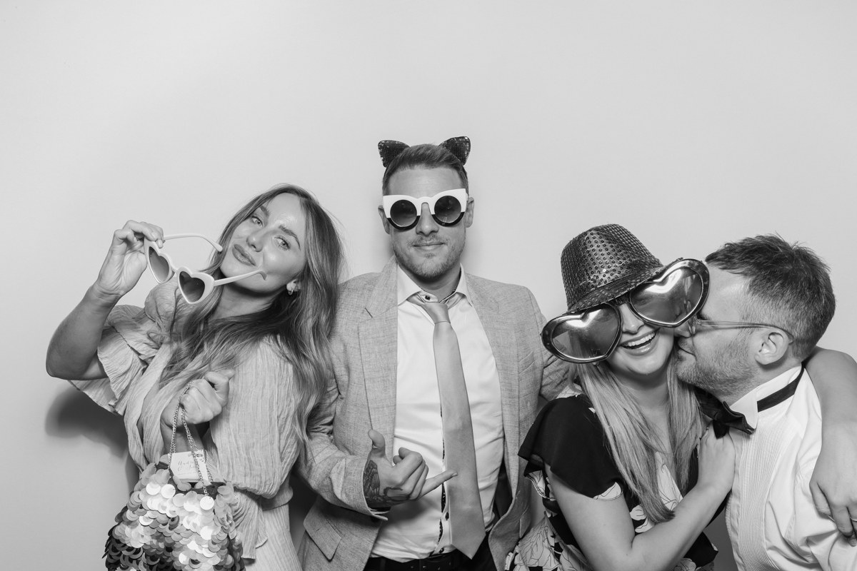 couples using the photo booth with a white backdrop for the kardashian style photo booth pictures