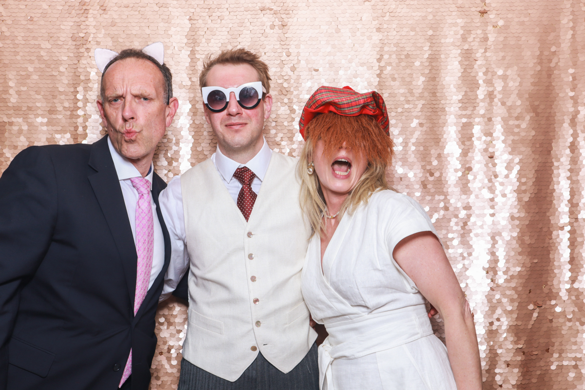 wedding guests using the photo booth during a wedding party in tetbury