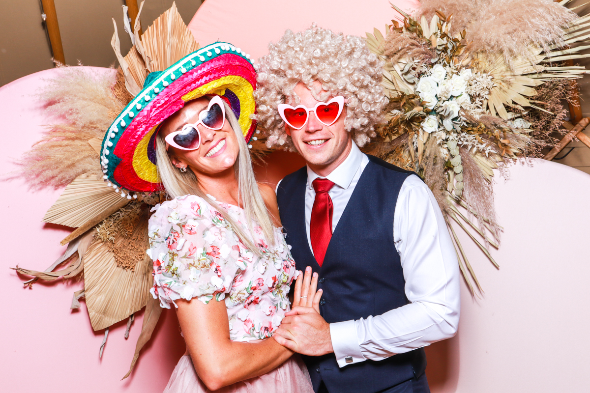 couple posing with props for a thorpe gardens photo booth hire 
