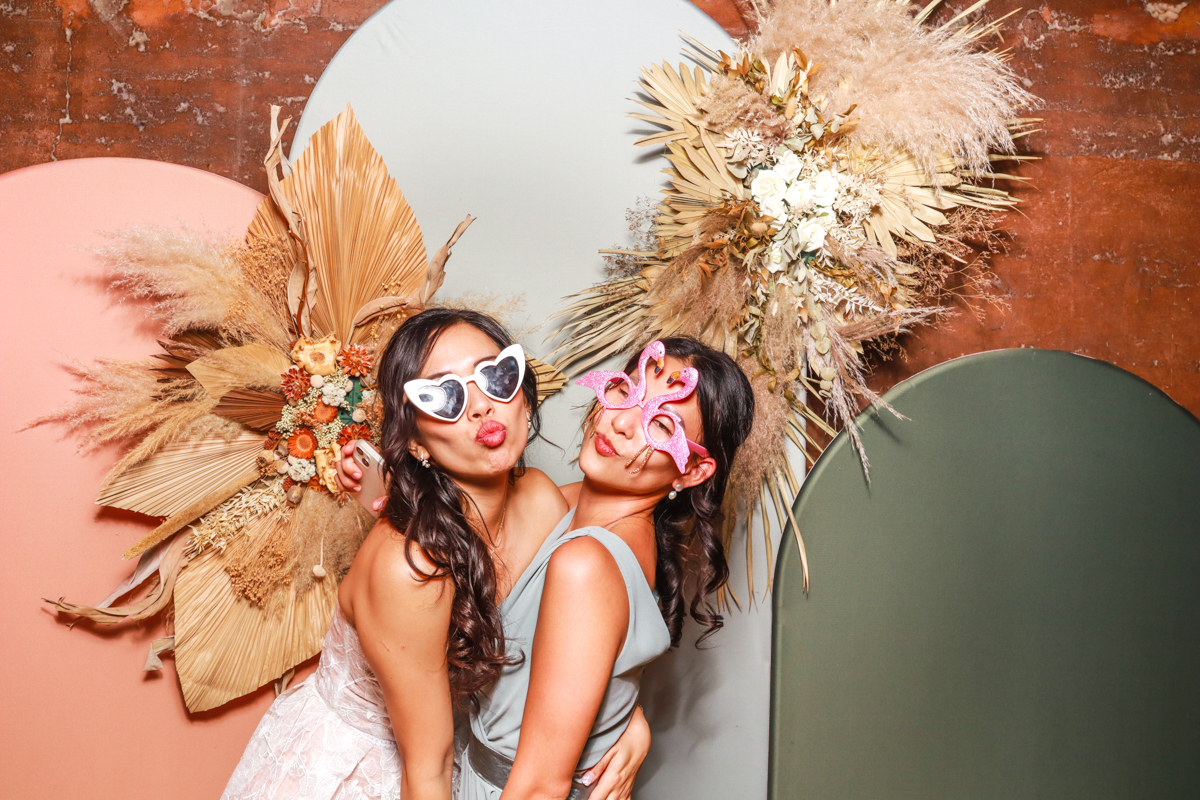 bride and friend posing for a photo booth rental in gloucester 