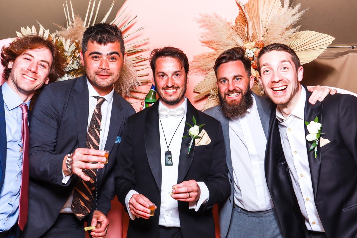 group of guys posing for a wooden photo booth hire at euridge manor cotswolds wedding